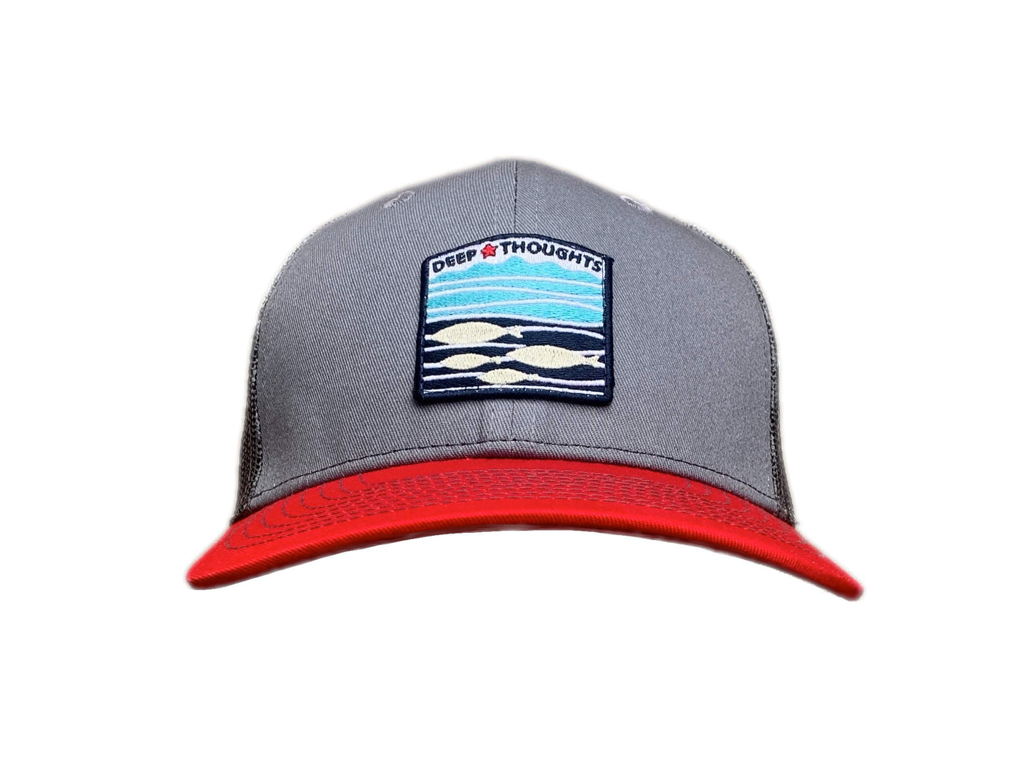Front view of grey red and charcoal trucker cap with red white and blue embroidered fish under waves patch