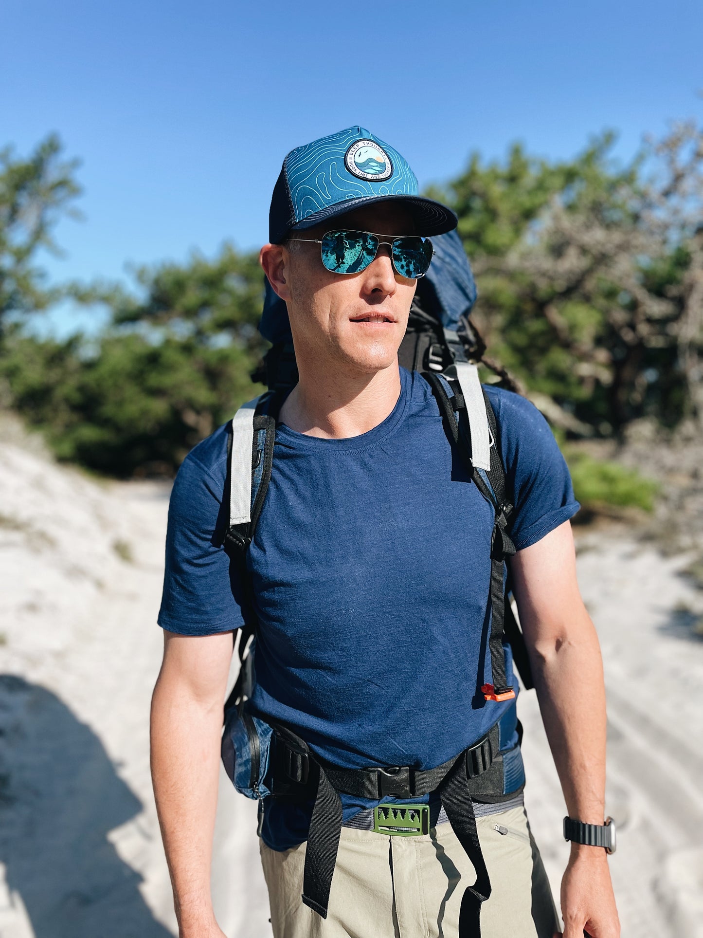 man wearing swell morning ocean topography map trucker cap