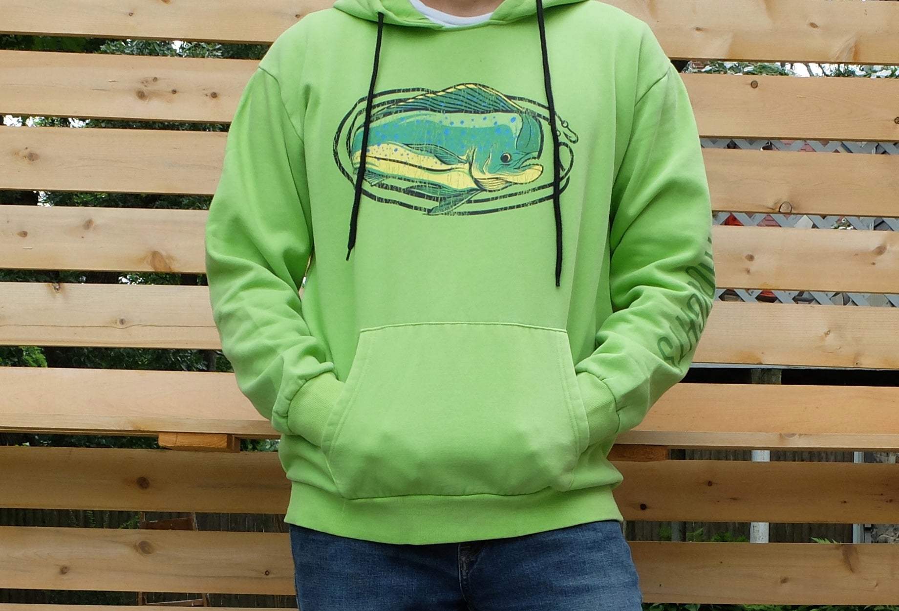 man wearing washed lime green hoodie with vintage style mahi mahi fishing graphic