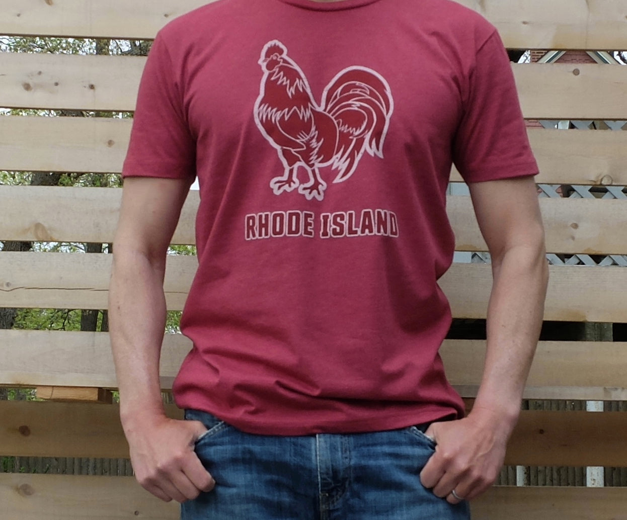 man wearing dark heather red t-shirt with Rhode Island Red chicken hen rooster graphic