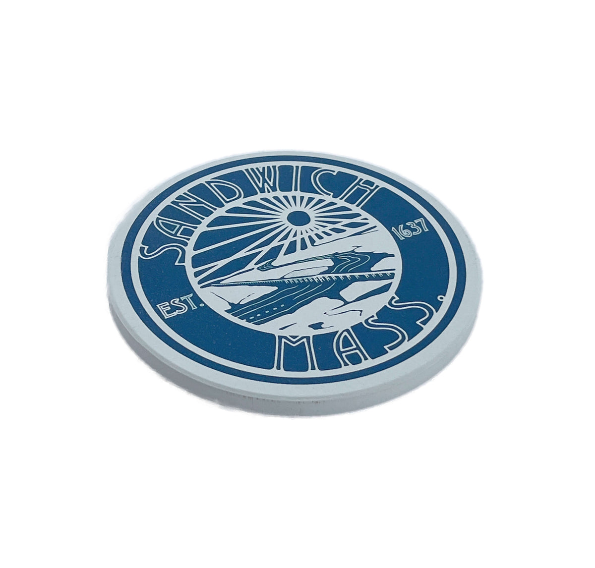 A circular blue and white ceramic drink coaster featuring the text 'SANDWICH MASS' with a stylized boat and sun graphic in the center, plus 'EST. 1637' on the sides, shown on a plain white background
