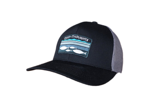 black and charcoal trucker cap with embroidered patch showing fish beneath shaded lines of water