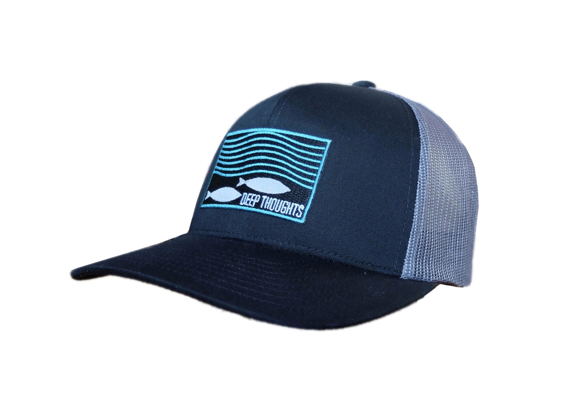 black and charcoal structured trucker hat with rectangular embroidered patch showing fish under wavy ocean currents