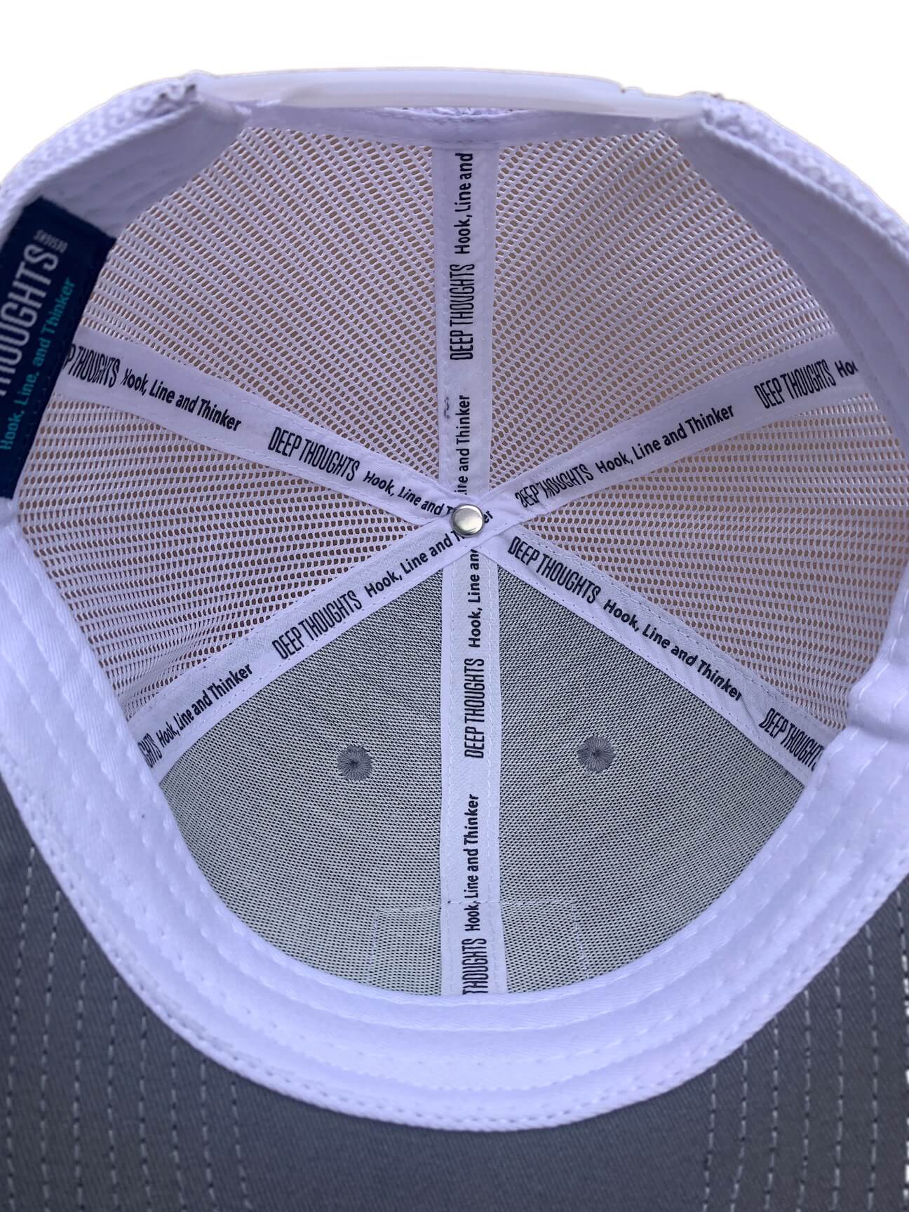Grey and white trucker cap with custom Hook Line and Thinker tagline on inner taping