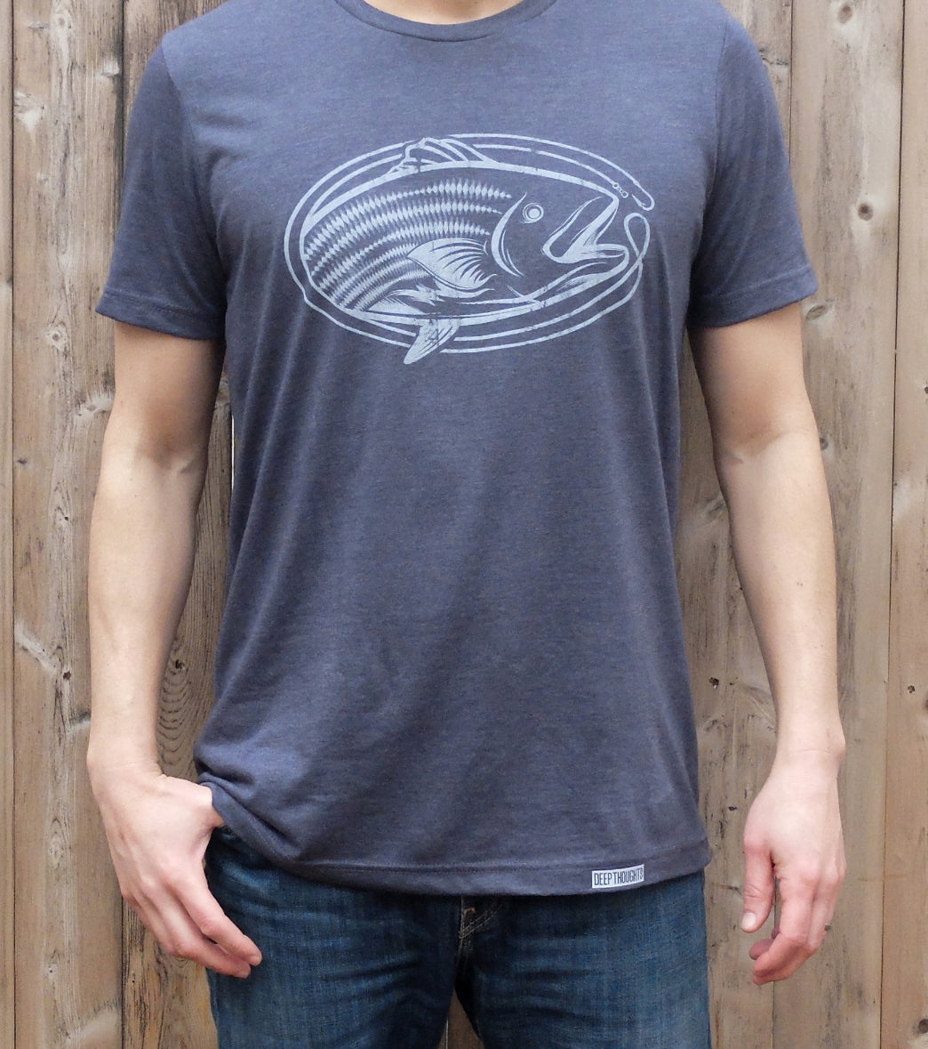 man wearing heather navy blue t-shirt with white oval-shaped striped bass fishing graphic