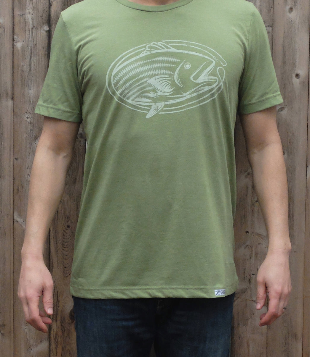 man wearing light heather green soft cotton blend tee with white vintage style oval-shaped striped bass fishing graphic