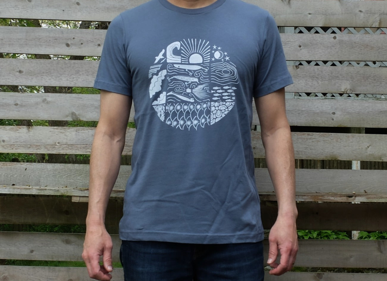 man wearing slate blue cotton t-shirt with white circular design showing multiple boating and fishing sights
