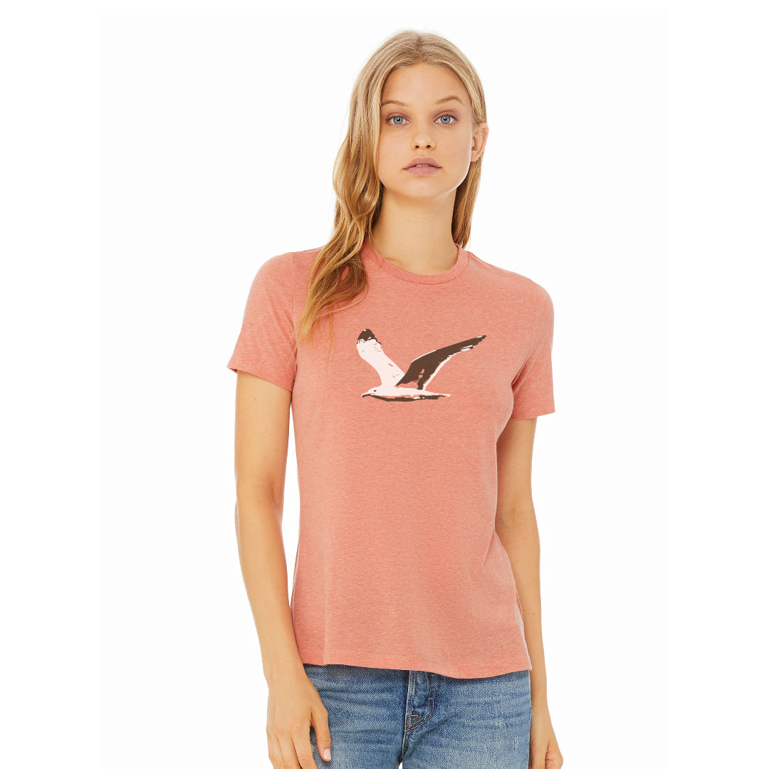 woman wearing light heather orange t-shirt with flying seagull graphic