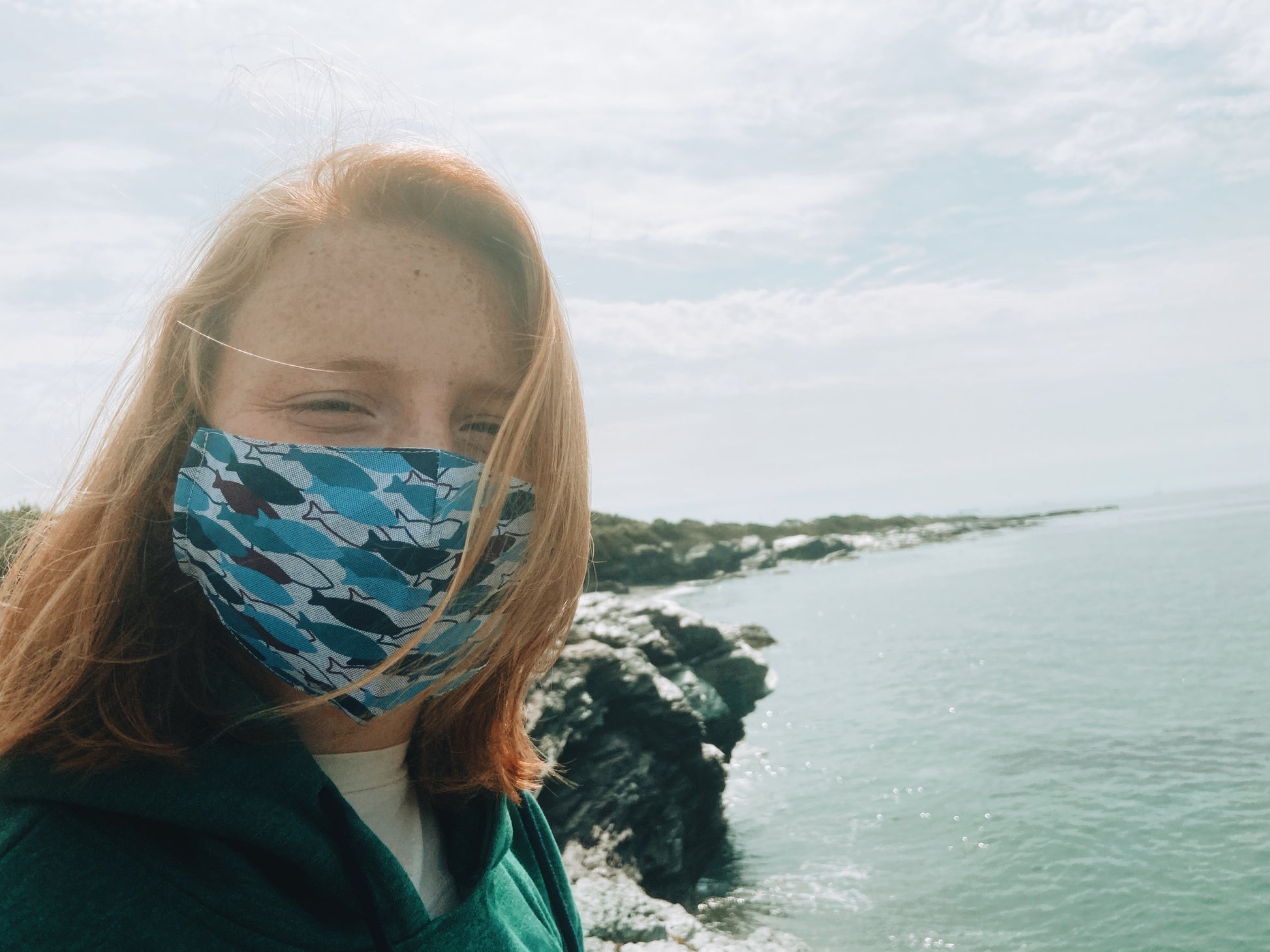 woman wearing cotton face mask with coastal fish pattern